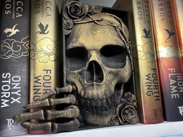 Gold skull with roses bookend on The Well Loved Shelf